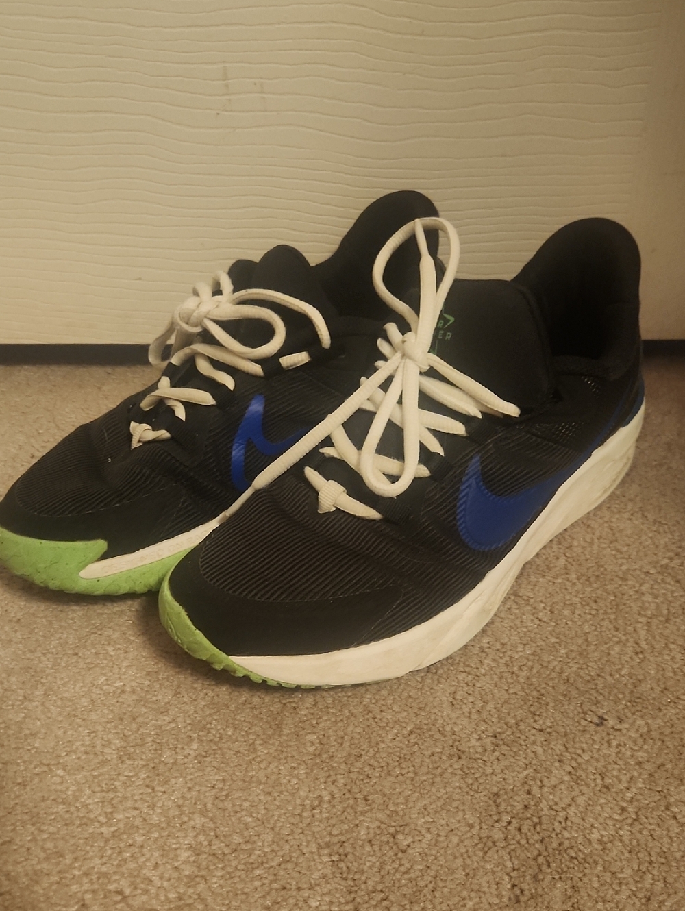 Nike Youth Black Sneakers with Blue Swoosh and Green Toe Accents